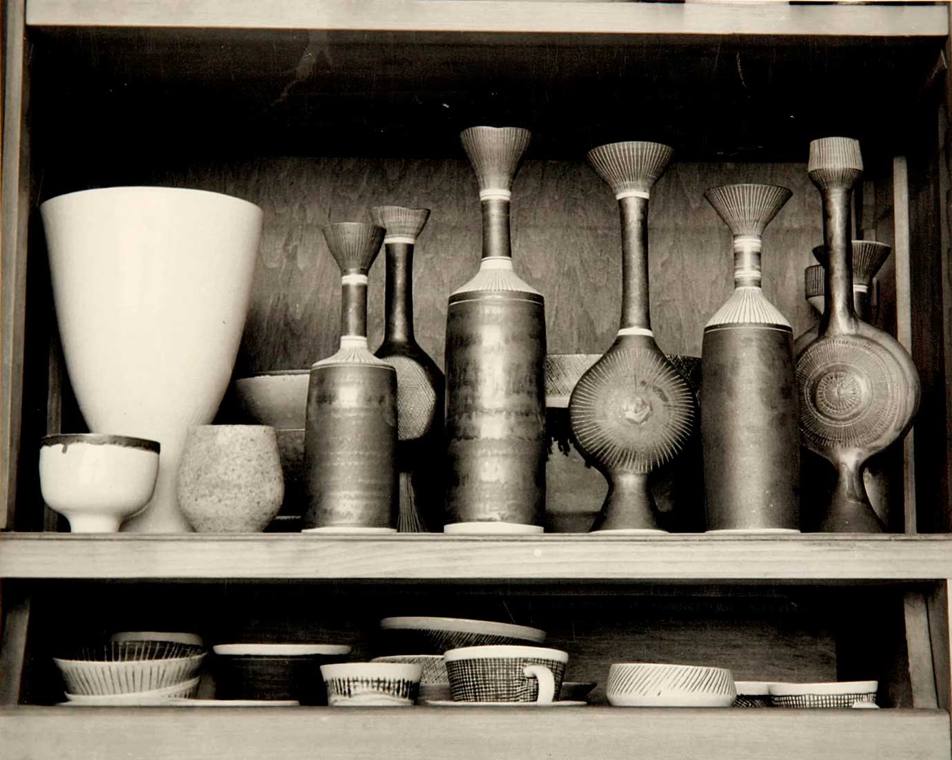 Pots by Lucie Rie arranged on a shelf