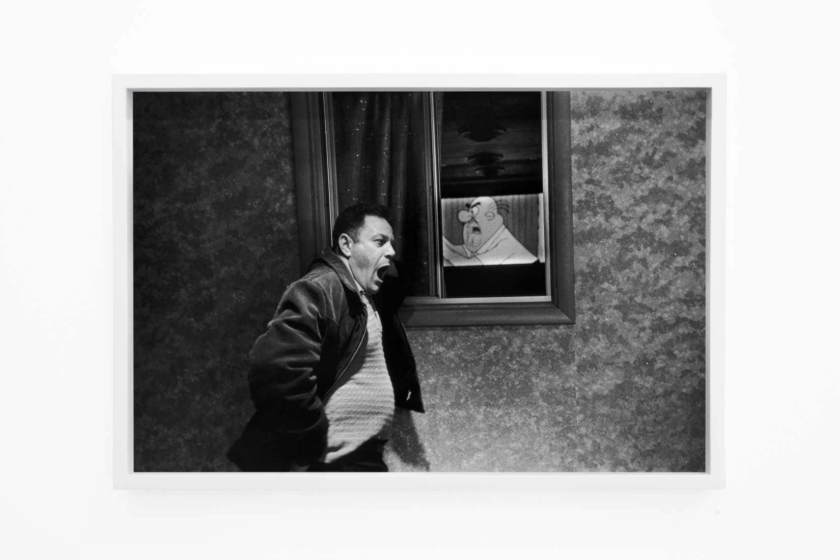 Photo of man yawning next to a cartoon.