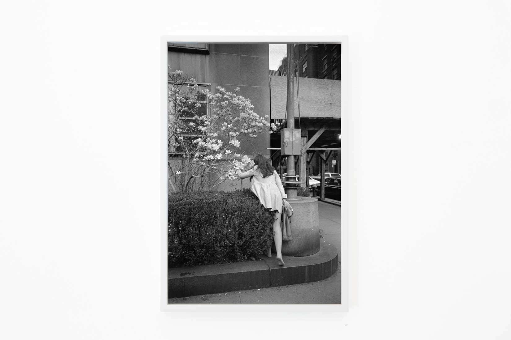 Black and white photo of a woman stepping onto a kerb.