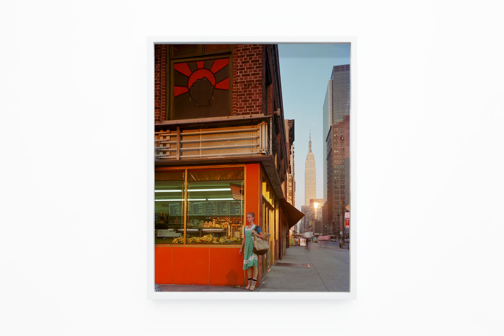 Photo of a ballerina standing outside a brightly coloured building in New York.