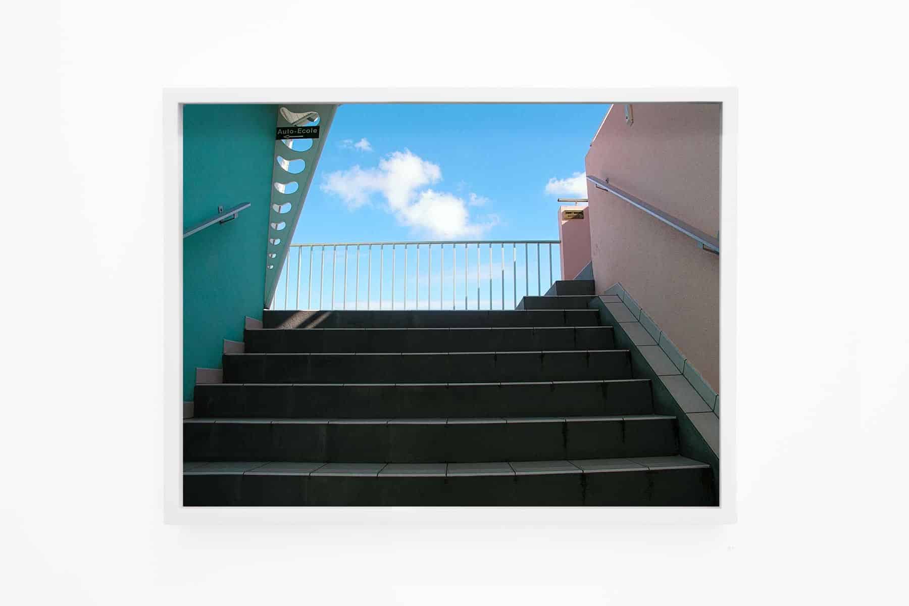 Photo of concrete steps leading towards blue sky.