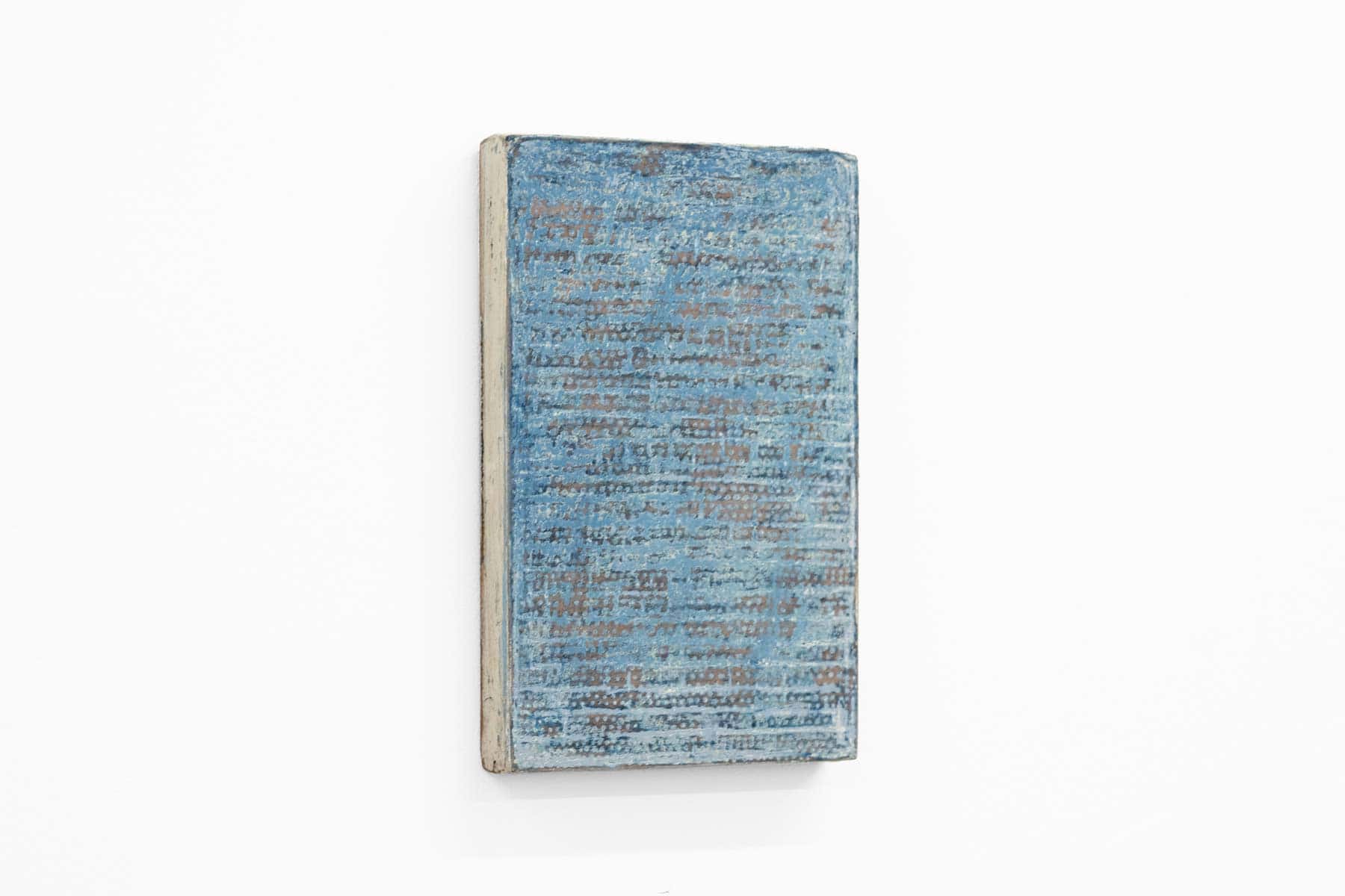 Abstract painting of speckled blue on paper and wood.