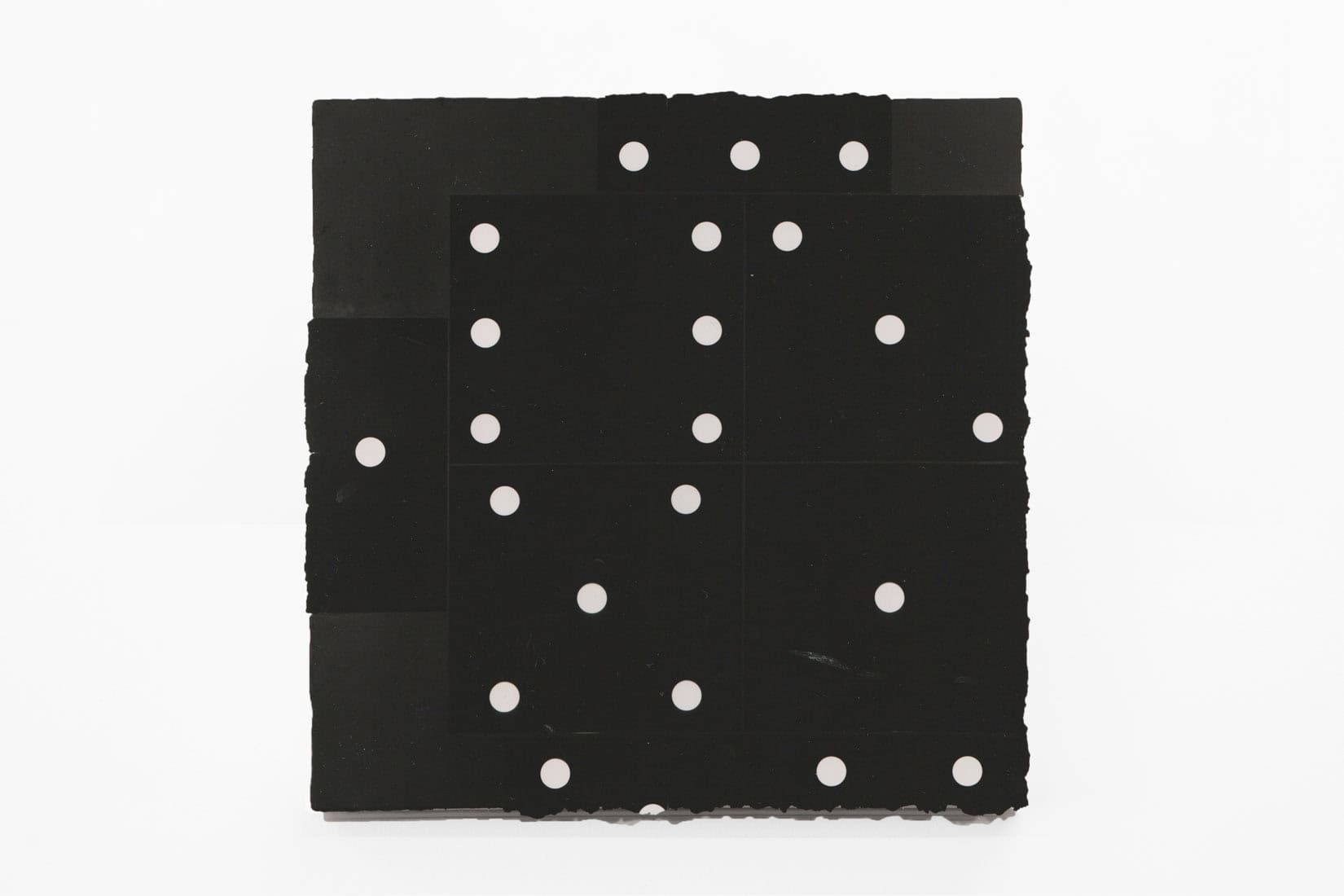 An artwork with a black background and white dots.